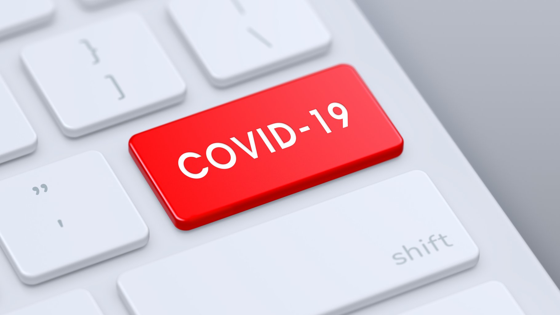 Eine Computertastatur mit einer auffälligen roten COVID-19-Taste, die eine der Standardtasten ersetzt und neben der weißen Umschalttaste liegt.